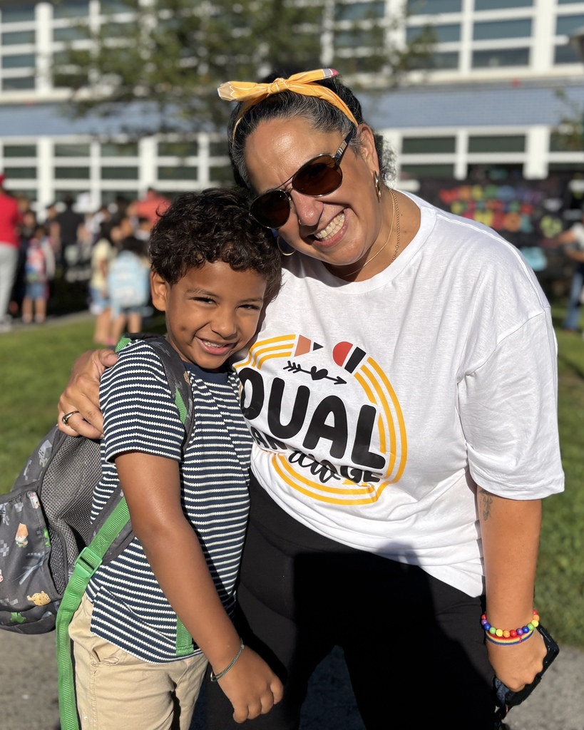 Principal Resendes stands with a student.