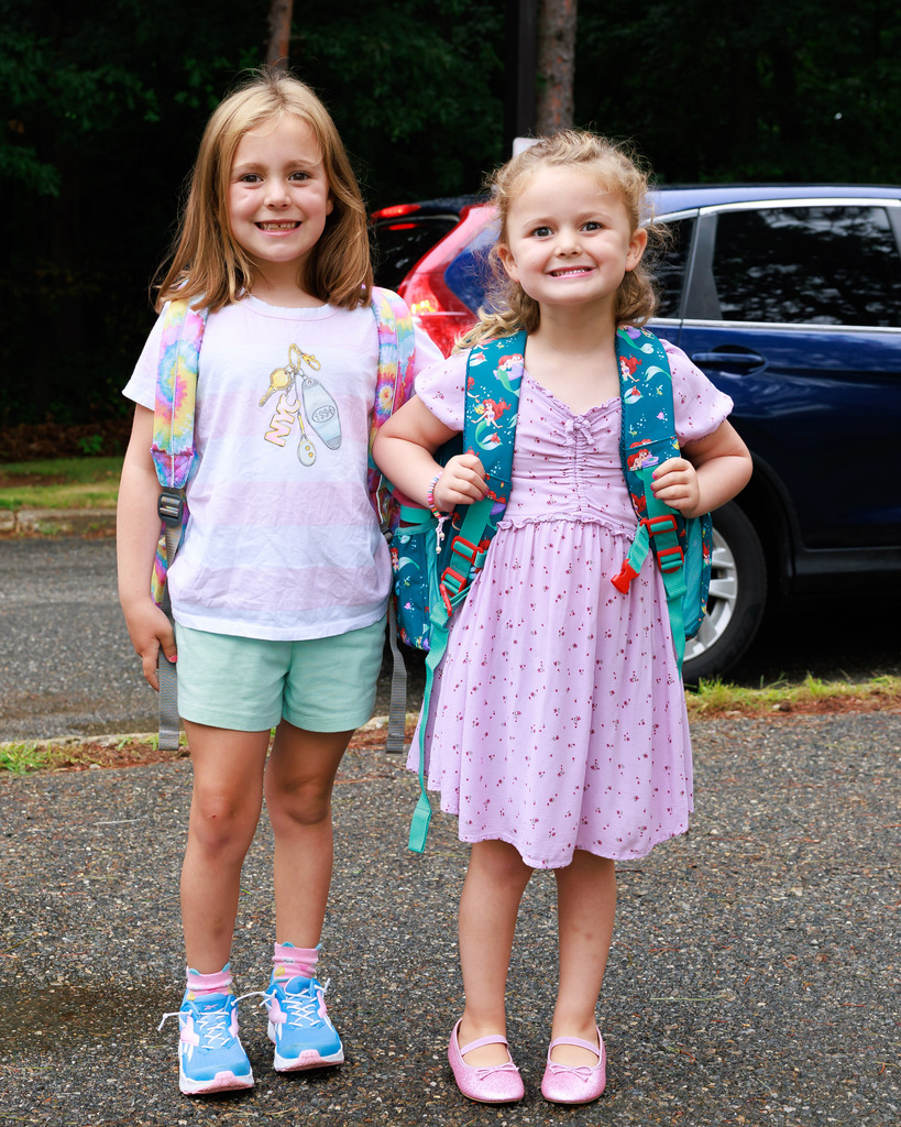 Two young students stand together on the first day or pre-k and kindergarten.Two young students stand together on the first day or pre-k and kindergarten.