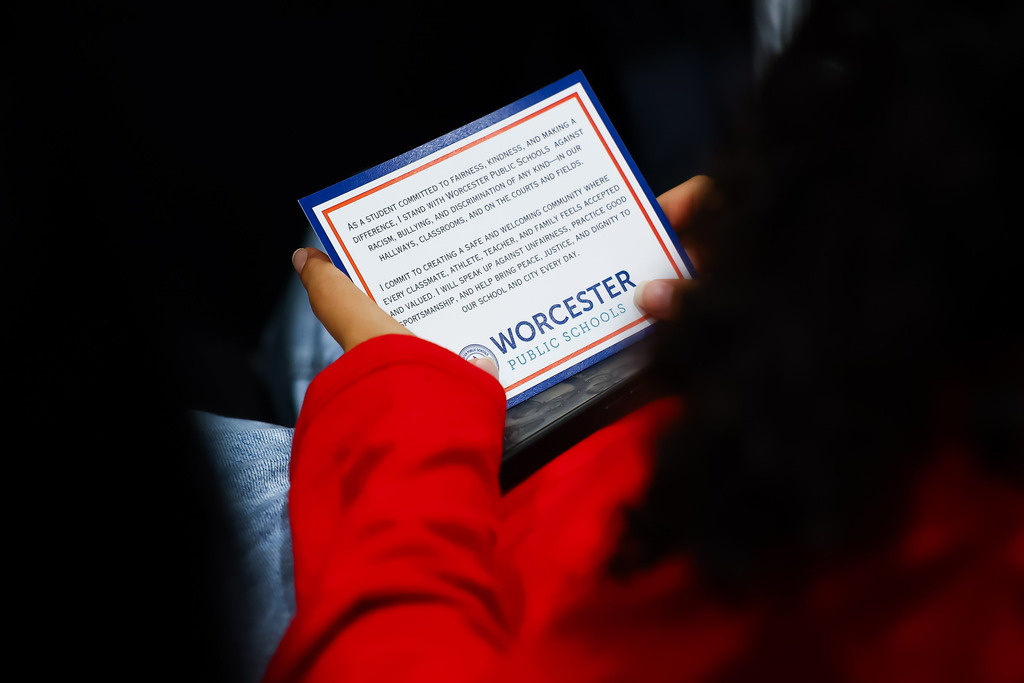 A student holds the Stand Against Racism student pledge card.