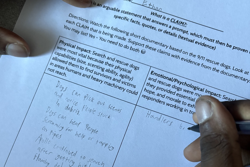 A student completes a worksheet during a lesson about 9/11 rescue dogs.
