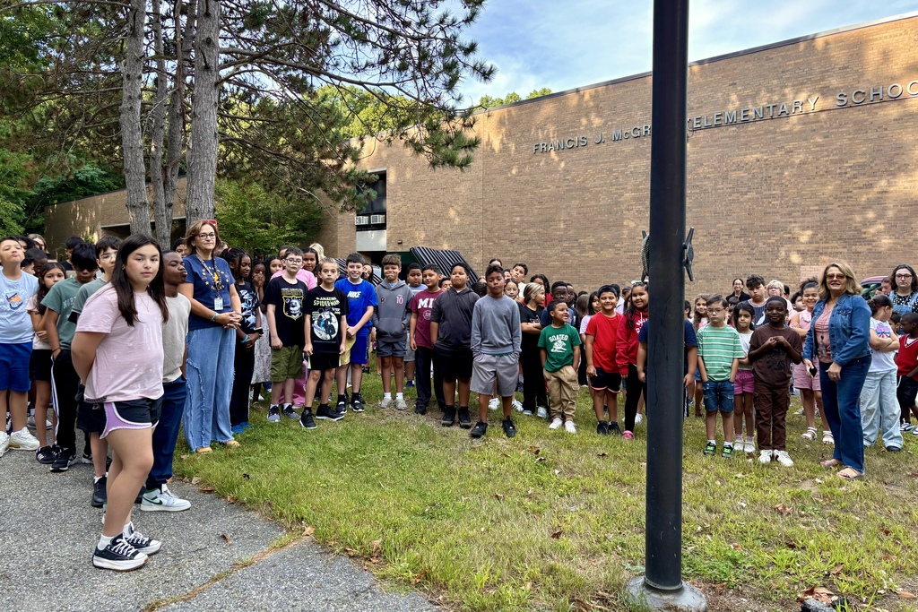 Students stand together outside of Francis J. McGrath Elementary School.
