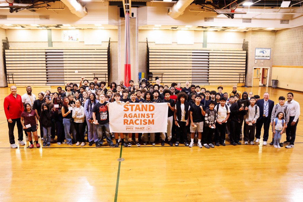 Student-athletes of Claremont Academy and University Park hold the Stand Against Racism banner.