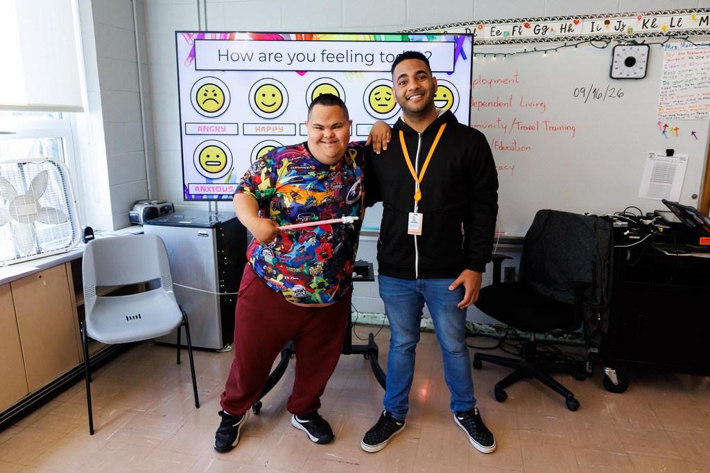 A student in the WPS transition department stands alongside a staff member.