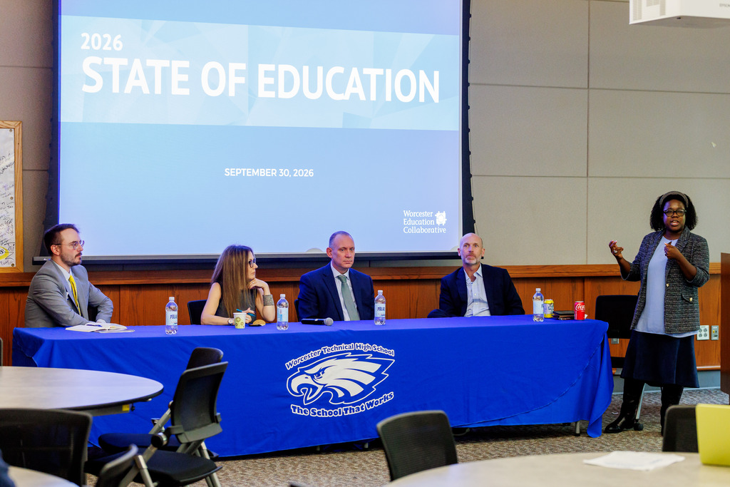 Speakers sit at a table for a Q/A session.