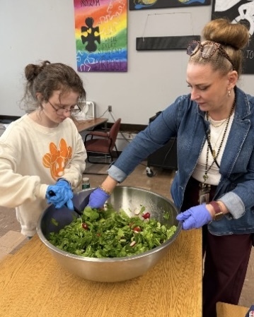 Students and staff in the WPS Transition Program clean and prepare vegetables for eating.