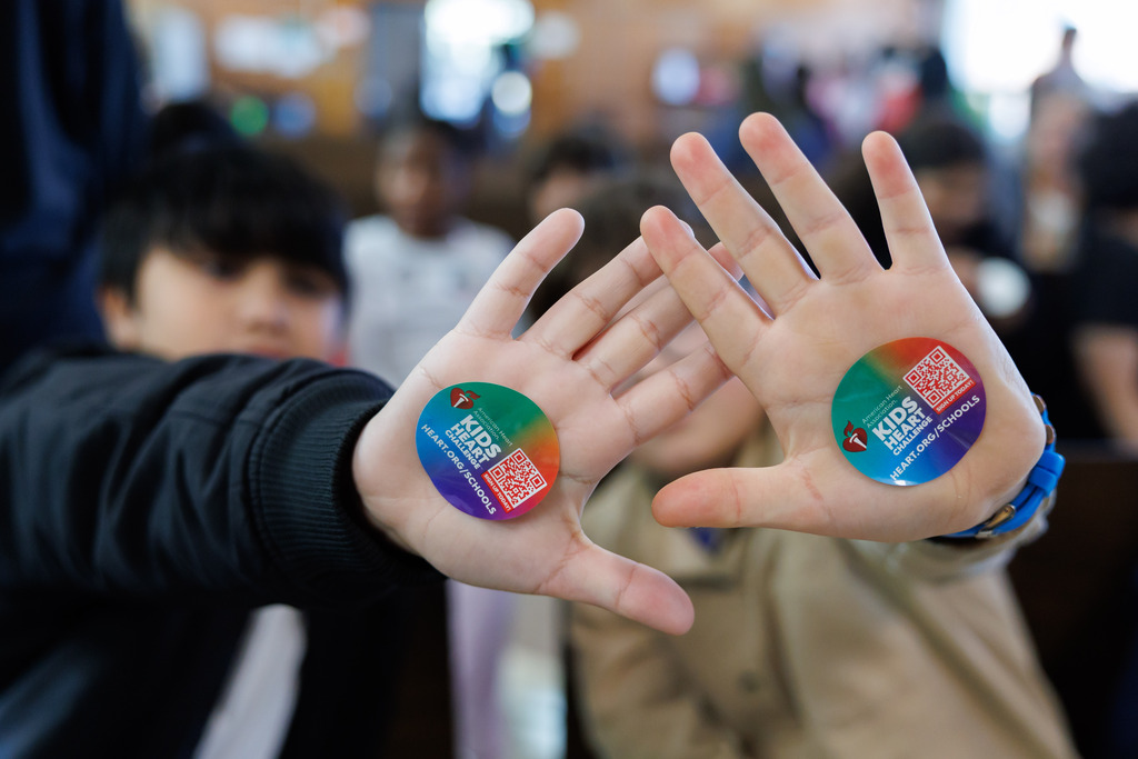 Students show off stickers from the American Heart Association.
