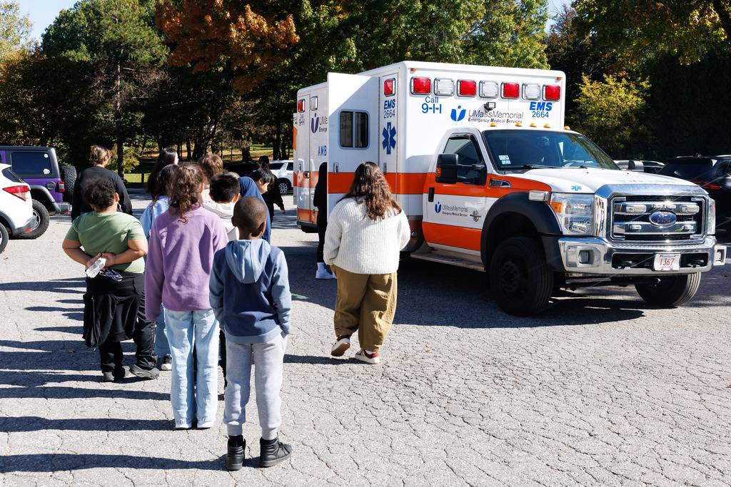 Students wait in line to tour an ambulance.