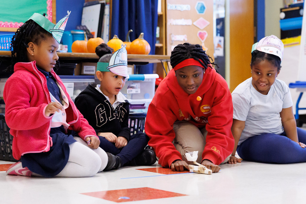 Students are intensely focused while launching a candy pumpkin with their catapult.