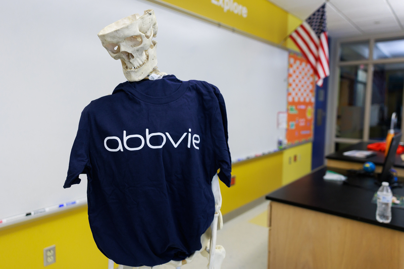 A science class skeleton wears an AbbVie t-shirt.