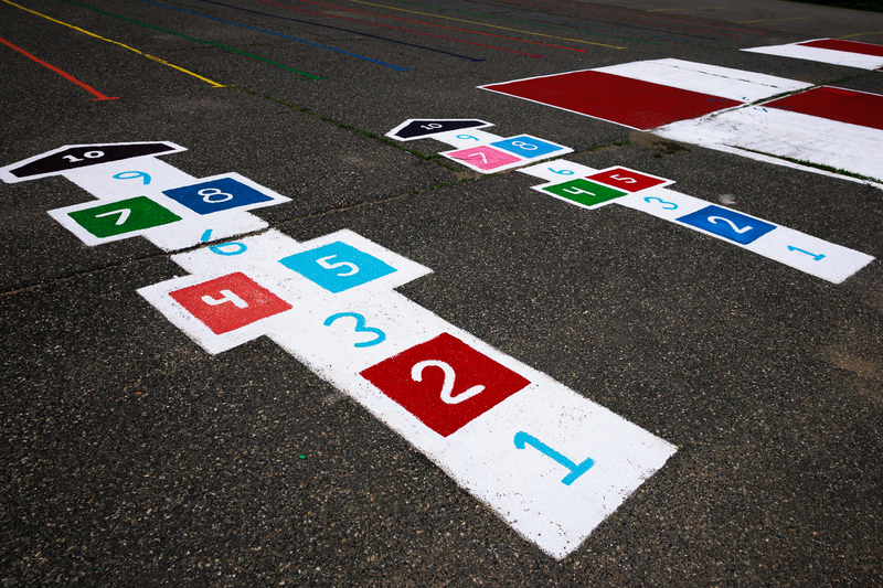 Refreshed sidewalk murals for hop scotch and other recess games.