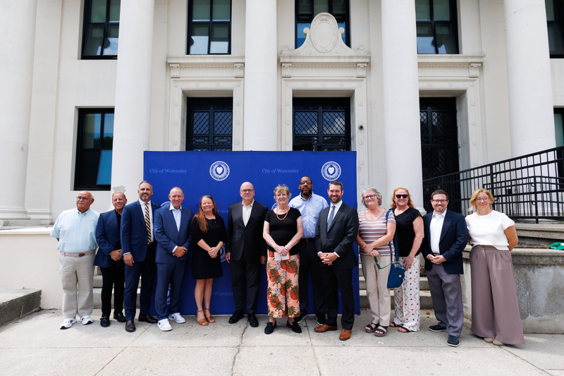 City and state officials stand together for a photo outside of Worcester East.