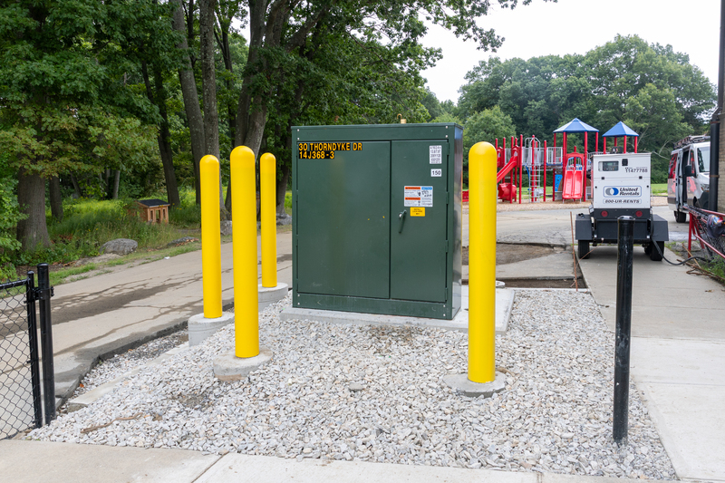 A green electrical generator with yellow poles.