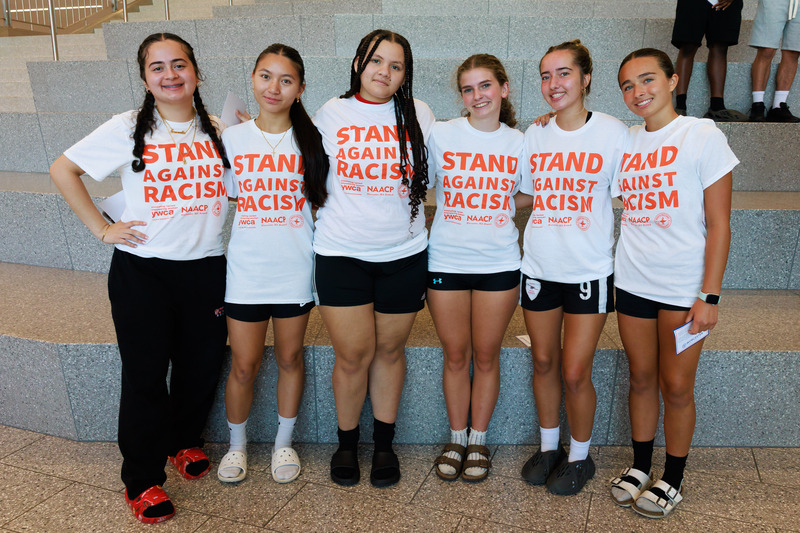 Students from South High stand together with shirts that say "Stand Against Racism."