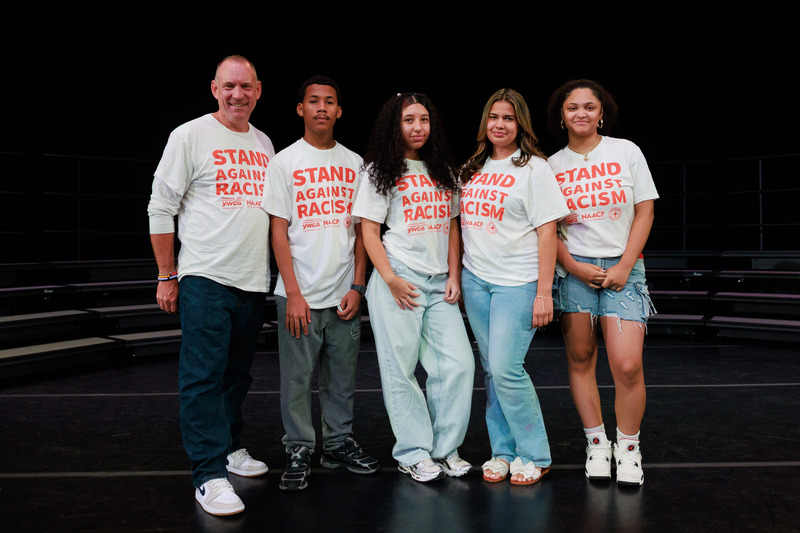 Students from University Park Campus School stand with Superintendent Brian E. Allen, wearing shirt that read "Stand Against Racism."