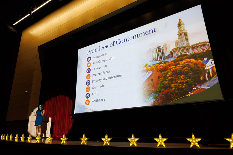 A woman gives a keynote presentation during an event.