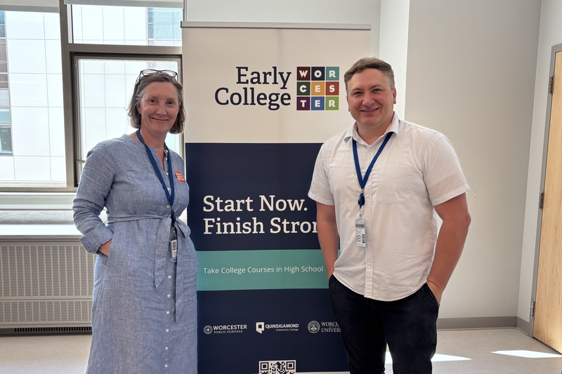 Early College staff stand in front of a banner.