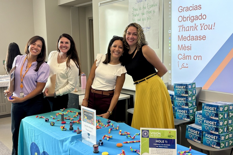 WPS Staff stand together behind a table.