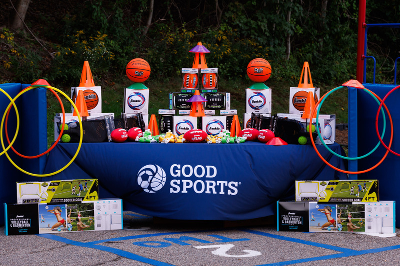 A table of sports equipment and the logo for Good Sports.
