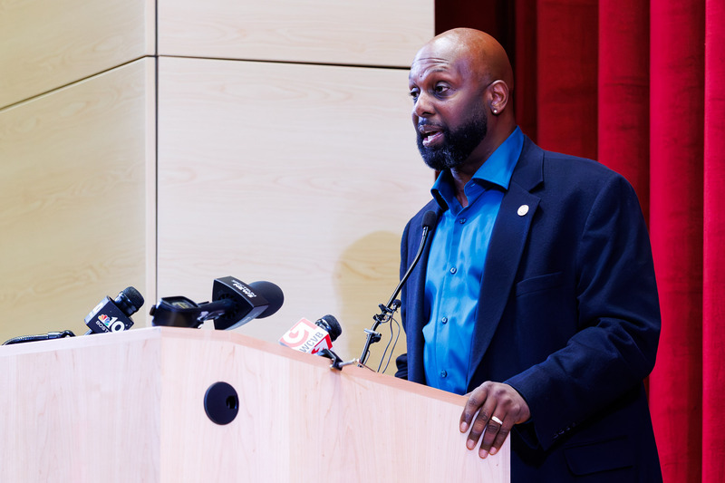 A man gives a speech at the podium.