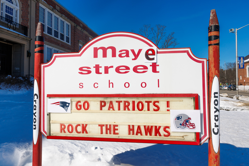 The "Maye Street School" sign with the words "Go Patriots, Rock the Hawks."