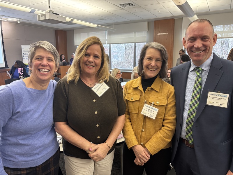 Four adults pose for a photo