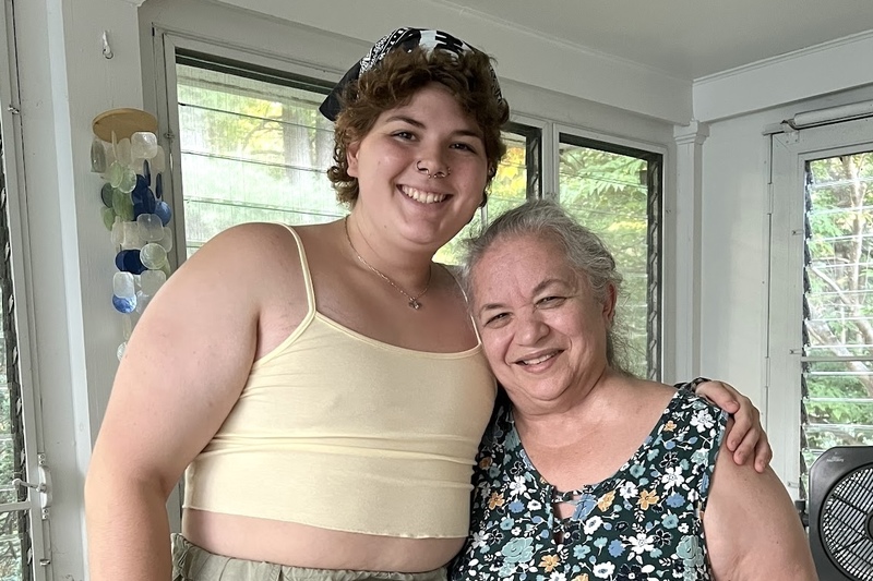 Jupiter Montalvo stands alongside Mrs. Manuel, their former elementary arts teacher.