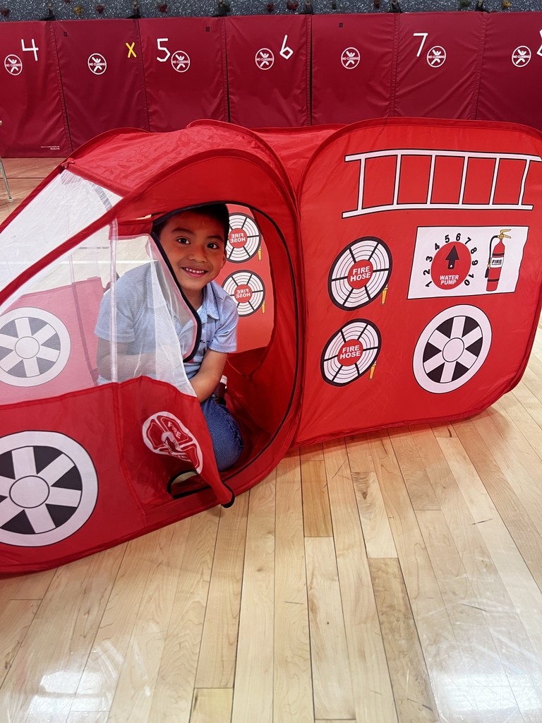 Boy in a firetruck tent