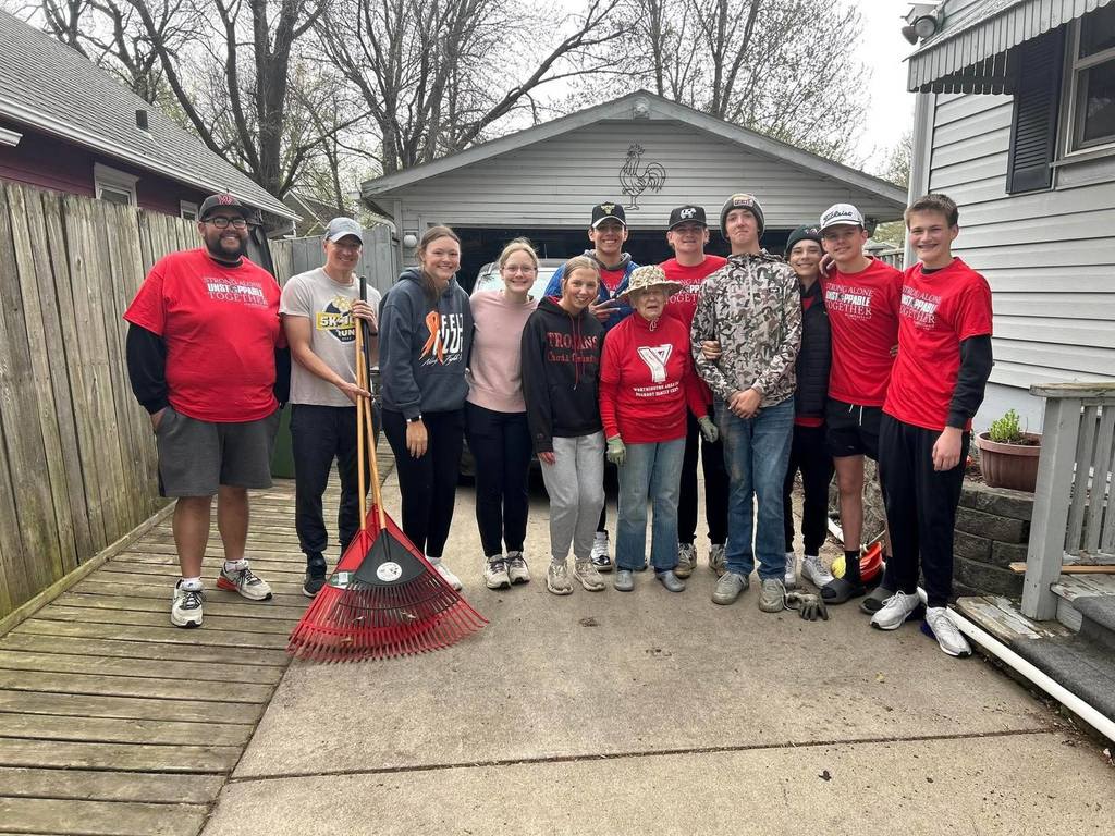 Group of students with community member that helped cleanup the outside