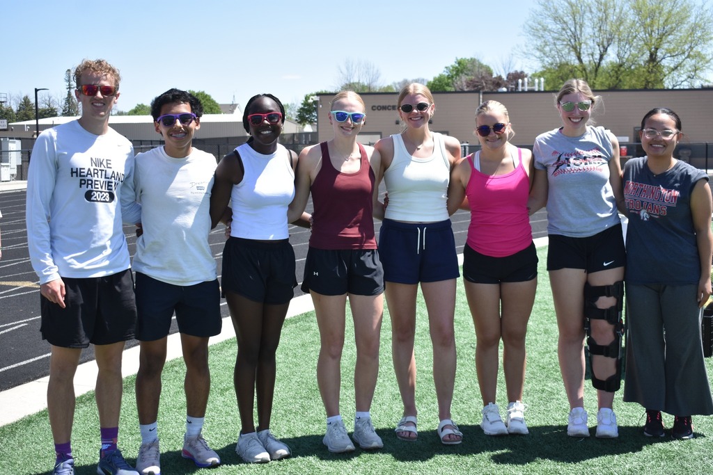 8 WHS students standing in a line on Trojan Field