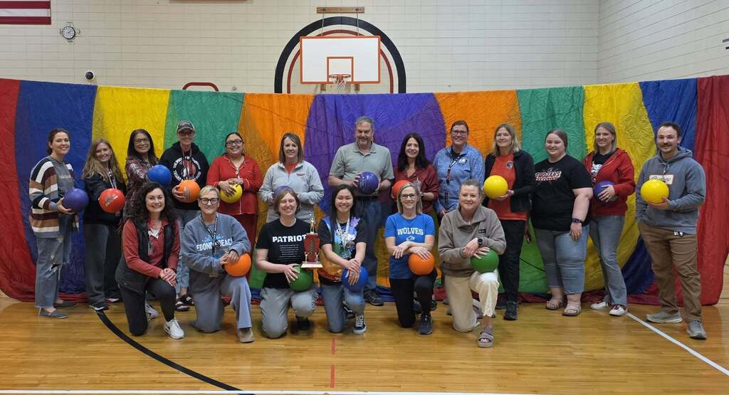 Teams from WMS staff in the WMS Gym with balls, nets 