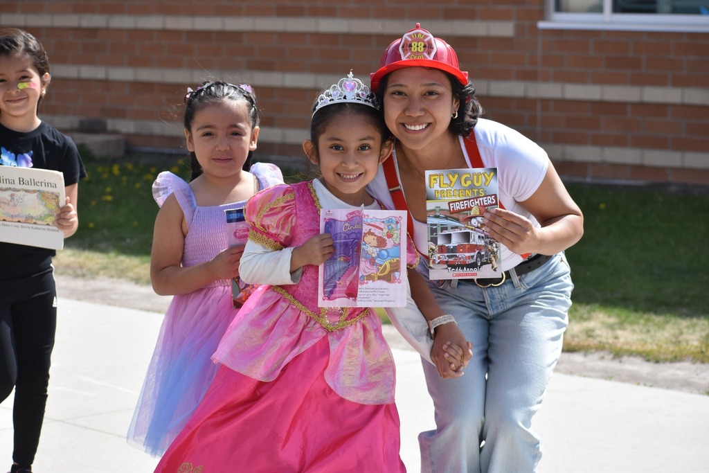 Teacher and students dressed in costumes holding books for Character Day