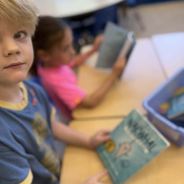 student posing with book