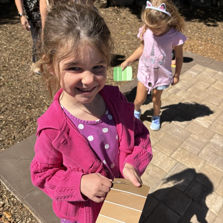 Little girls looking for nature items and matching to paint chip