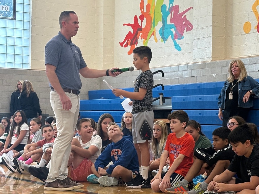 Student talking into microphone sharing their class's hopes and dreams for the school year.