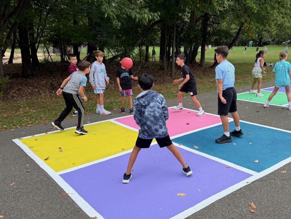 Students playing four square
