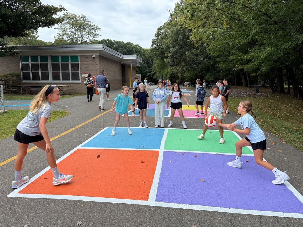 Students playing four square