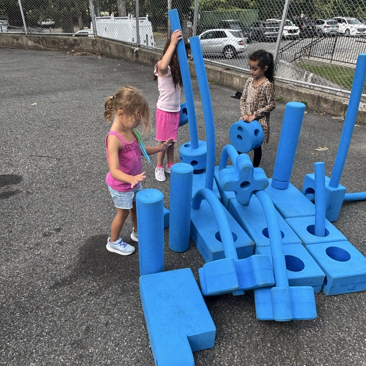 girls playing with outdoor blocks