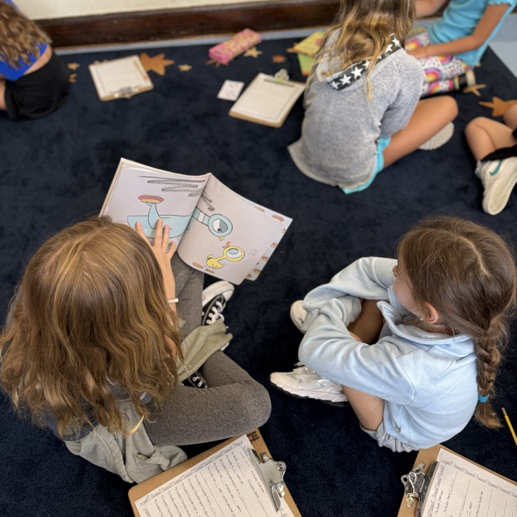 girls reading on rug