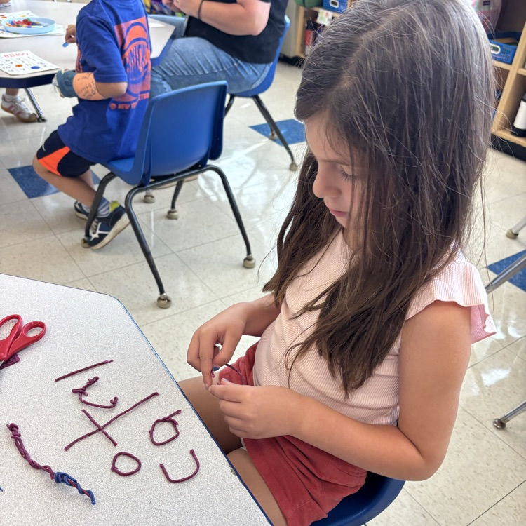 girl making letters