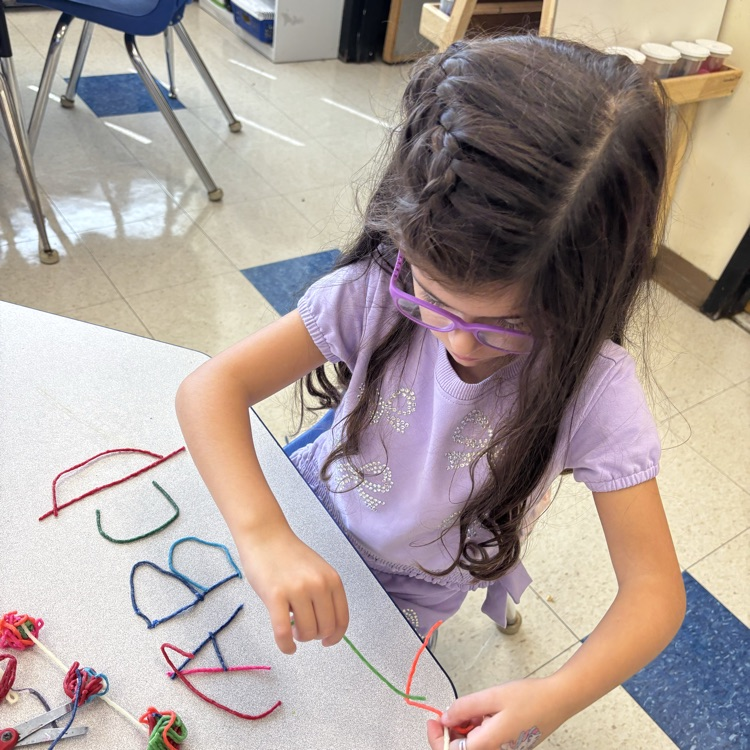 girl making letters