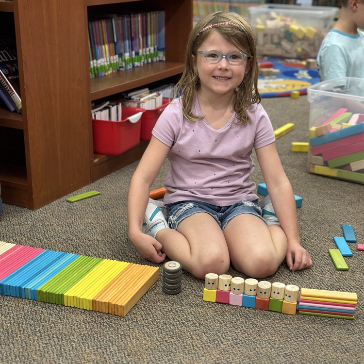 student showing her Tegu block build