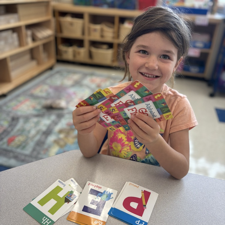 Little girl holding cards