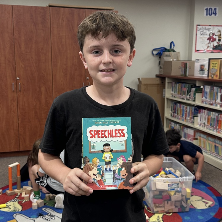 student holding new book 