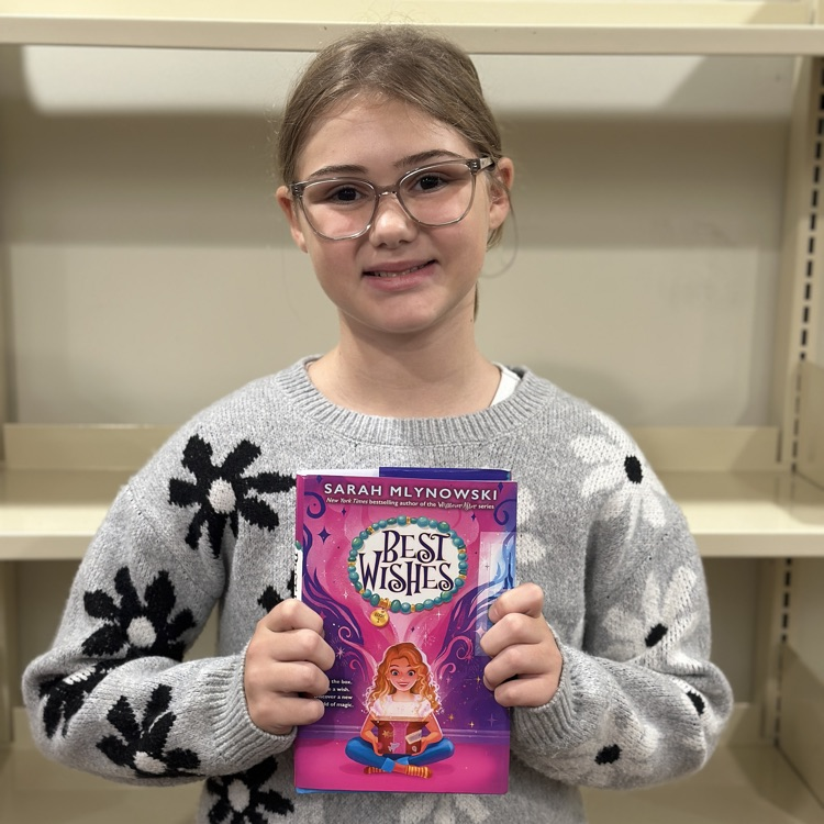student holding new book