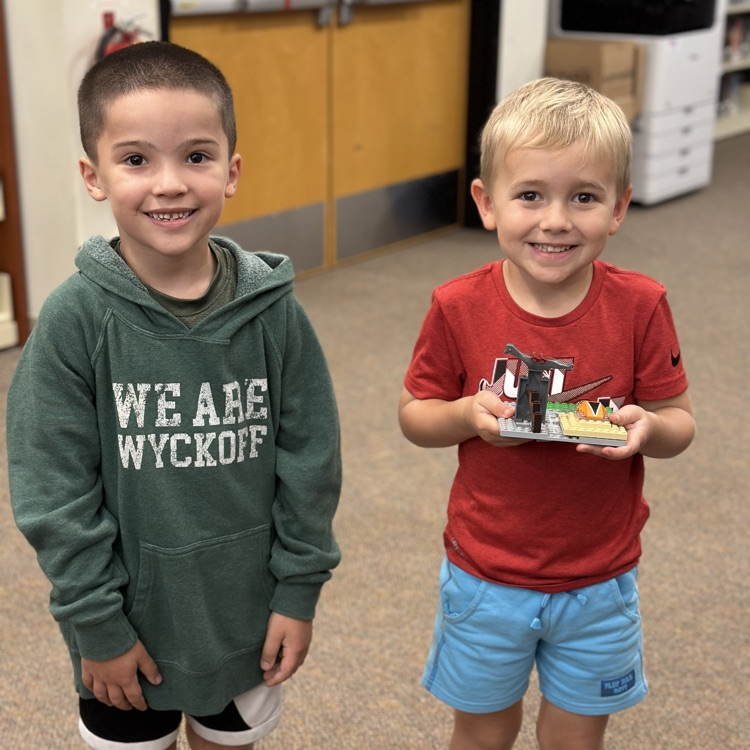 students holding Lego creation 