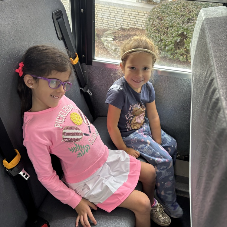 two girls sitting on a bus