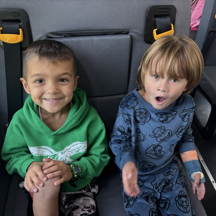 two children sitting on a bus