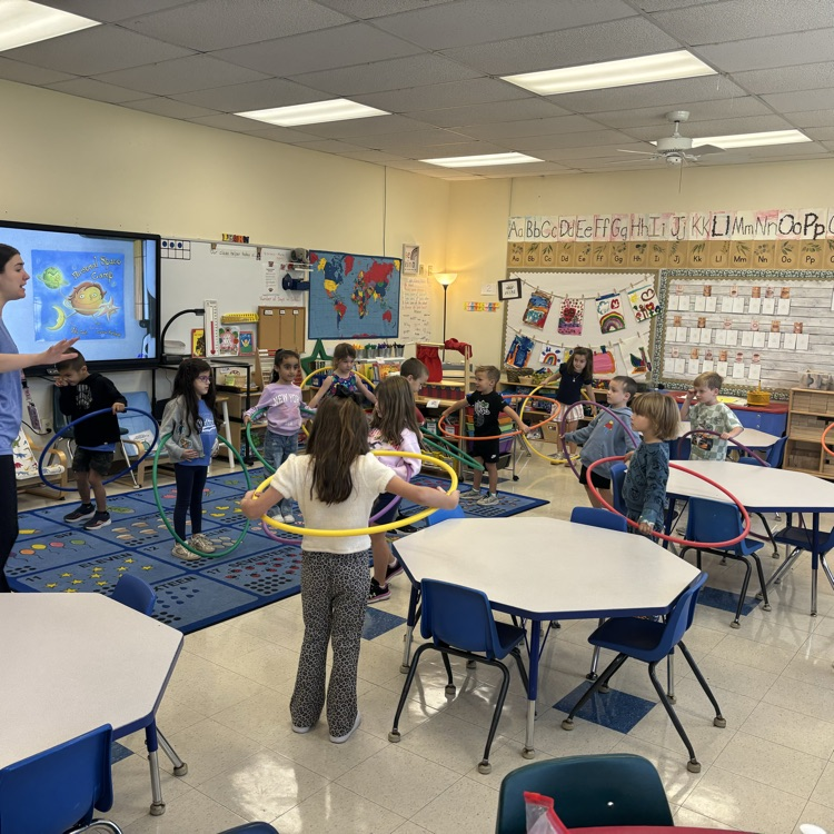 children with hula hoops in the classroom