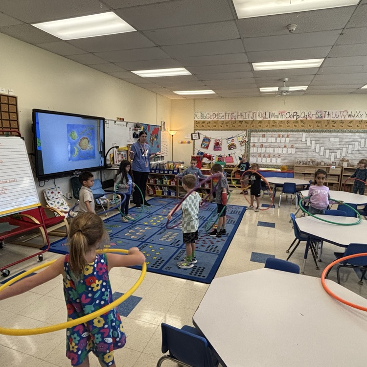children with hula hoops in the classroom