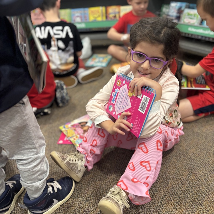 girl holding books